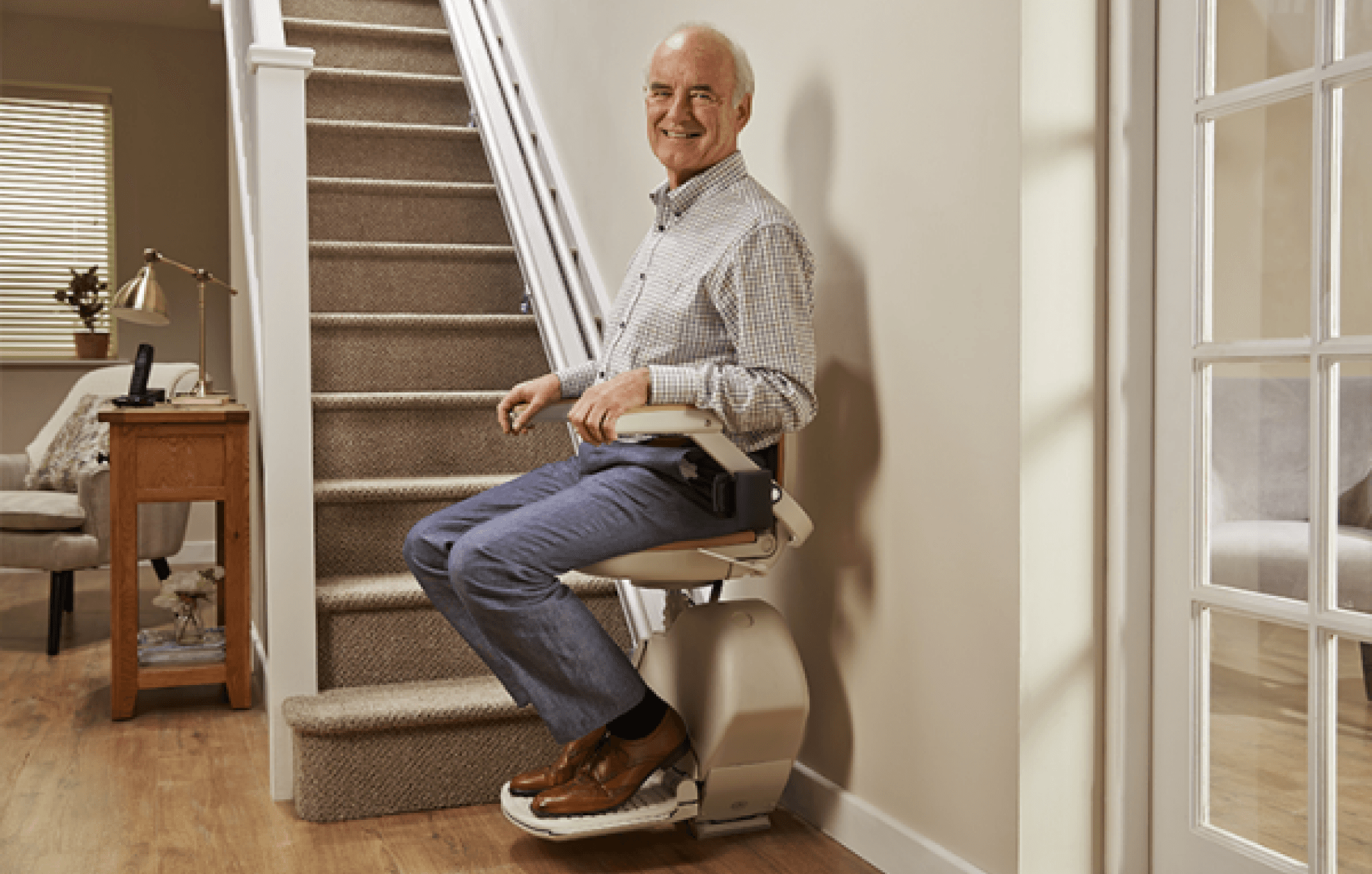 Elderly man on straight stair lift