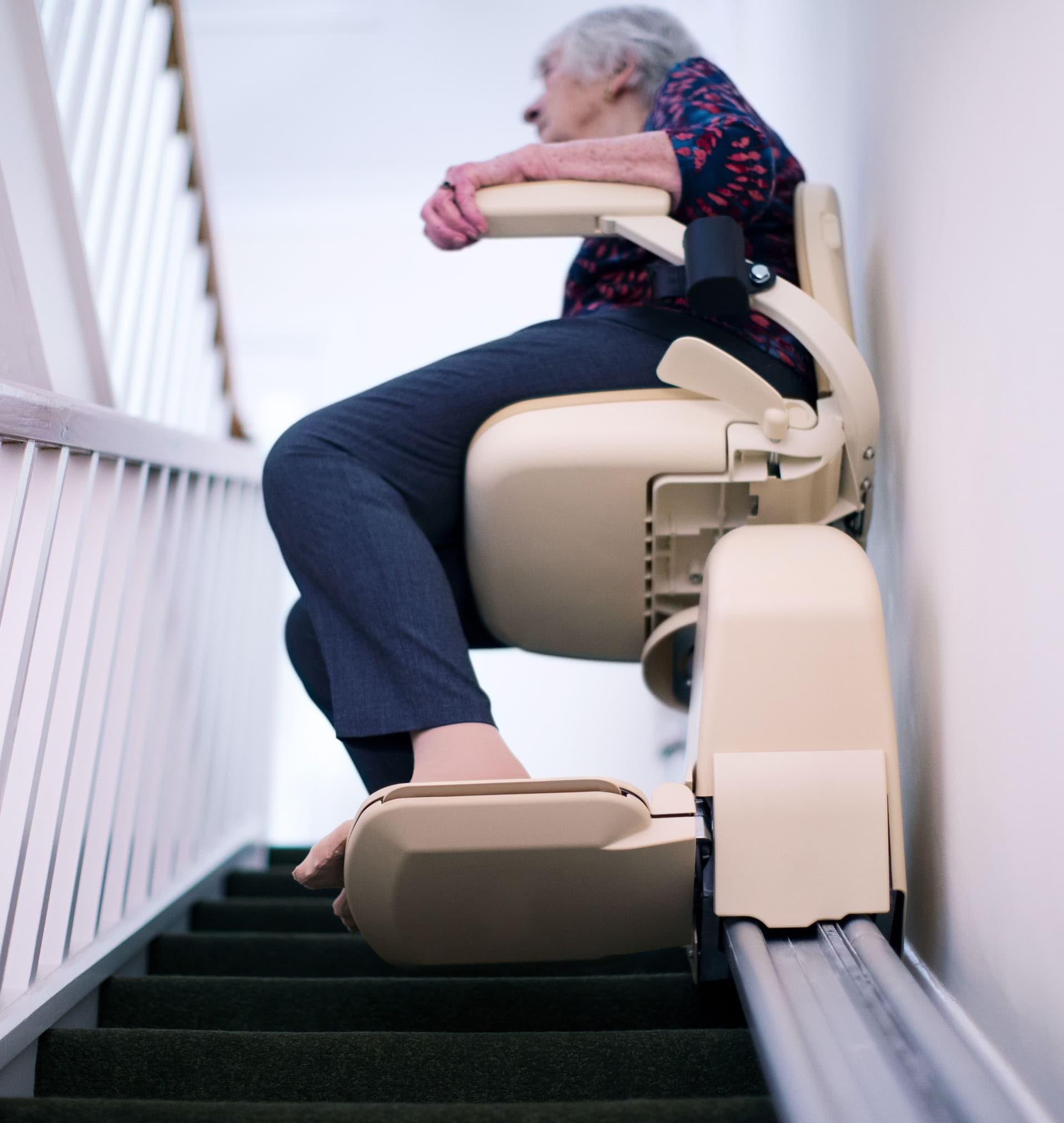 Elderly lady on a stairlift